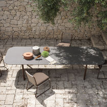 Tavolo da pranzo moderno / in pietra / con...