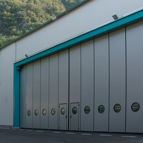Porta industriale scorrevole - LE, LN, LG, SN, BT series - SILVELOX GROUP SPA - a libro / in lamiera / in poliuretano