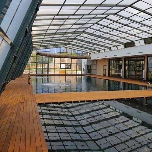 Copertura per piscina alta - EVOLUTION LEAN-TO - Evergreen Solutions - a parete / retrattile / in alluminio