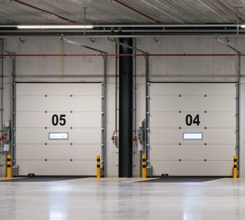 Porta industriale sezionale - CRAWFORD OH1142P DUAL DRIVE - ASSA ABLOY Entrance Systems - di acciaio / termoisolante / automatica