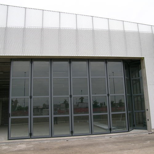 Porta industriale a libro - FOLDING GLASS - Moreschi Chiusure Industriali S.r.l. - ad impacchettamento / in acciaio / in acciaio galvanizzato