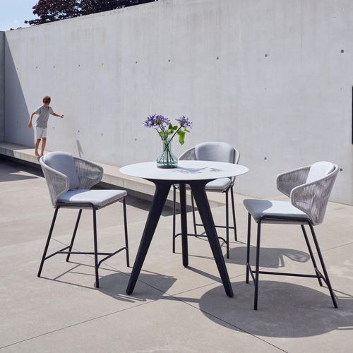 Tavolo alto contemporaneo - Torsa  - MANUTTI - in ceramica / con supporto in teak / rotondo