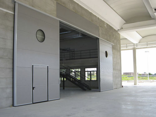 Porta industriale sezionale - ALLMURA - MURA - scorrevole / in metallo / per edifici pubblici