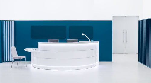 Banco reception modulare - VALDE - MDD - a semicerchio / in laminato / in vetro
