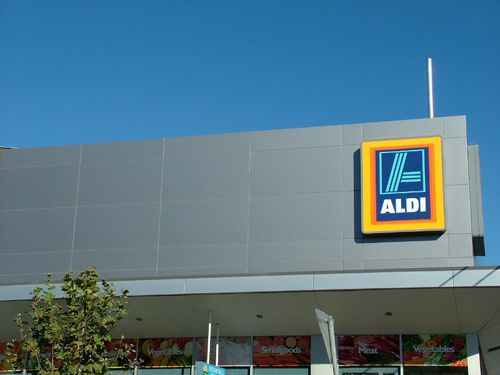 Rivestimento di facciata in pannelli - ALDI STORES - VITRAPANEL - Vitragroup - in fibrocemento / lucido