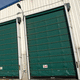 porta industriale sezionale / in acciaio inossidabile / di grande altezza / resistente alla corrosione