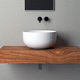 lavabo da appoggio / in ceramica / con piano integrato / rotondo