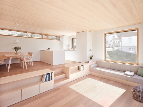 Il legno chiaro utilizzato in tutto l'interno di questa casa duplex lo mantiene luminoso e moderno